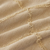 Macro of the Oat Beige fabric showing the raised tufted Luxe Diamond lattice texture