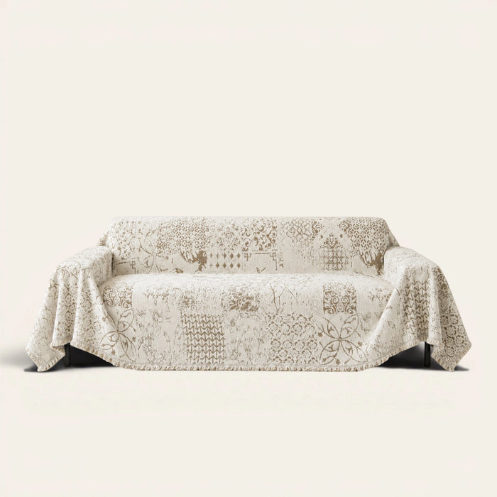 Luxe Heritage cream latte sofa throw draped over a couch, front view on an ivory backdrop
