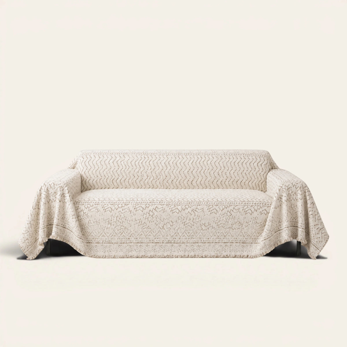 Luxe Heritage Oat Ivory sofa throw draped over a three-seat sofa, front view on ivory