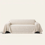 Luxe Heritage Oat Ivory sofa throw draped over a three-seat sofa, front view on ivory