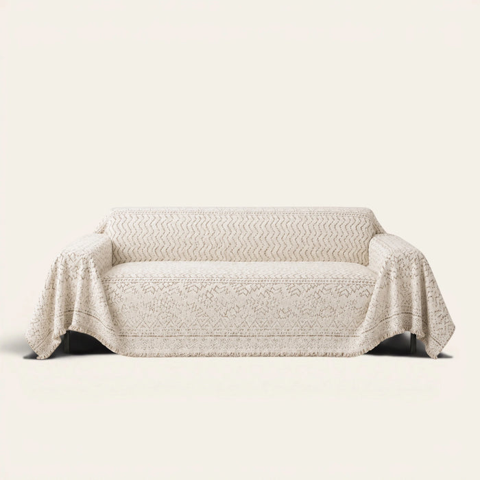 Luxe Heritage Oat Ivory sofa throw draped over a three-seat sofa, front view on ivory