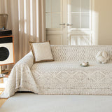 Oat Ivory Luxe Heritage throw styled on a sunlit sofa with boucle and flower cushions