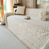 Luxe Heritage Oat Ivory throw on a sofa with flower cushion and mug, angled view