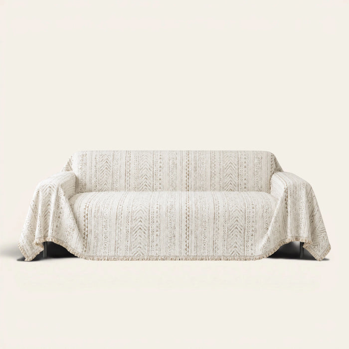 Pearl Beige Luxe Heritage textured throw draped over a two-seat sofa on ivory background