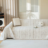 Pearl beige heritage throw covering a sofa with boucle cushion, cup and record player