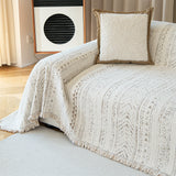 Luxe Heritage throw draped over a sofa corner beside framed art and a boucle cushion