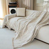 Pearl beige heritage throw styled across a sofa with cushion and record player