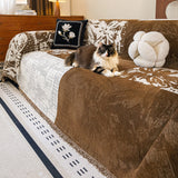 Mocha Pearl Luxe Patchwork throw on a sofa with a fluffy cat resting, a floral cushion in a mid-century room