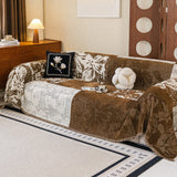 Wider view of Mocha Pearl Luxe Patchwork throw over a sofa with cushions, a lamp and a retro screen