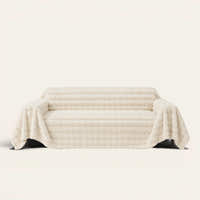 Luxe Ripple faux fur sofa throw in Ivory Luxe draped over a couch, front view on ivory background