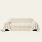 Luxe Ripple faux fur sofa throw in Ivory Luxe draped over a couch, front view on ivory background