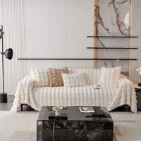 Ivory Luxe Luxe Ripple faux fur throw styled on a sofa with cushions in a modern living room