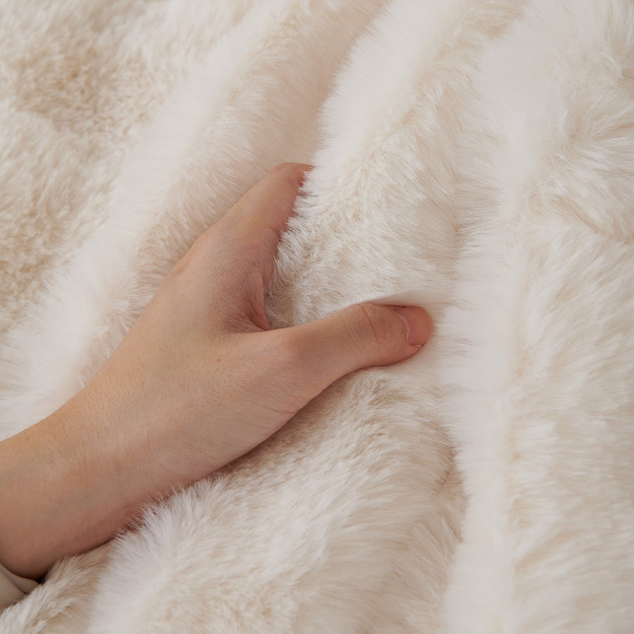 Macro of a hand pressing into the soft Ivory Luxe Luxe Ripple faux fur texture