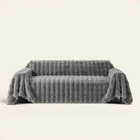 Smoky Quartz Luxe Ripple sofa throw draped over a full couch, front view on ivory background