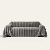 Smoky Quartz Luxe Ripple sofa throw draped over a full couch, front view on ivory background