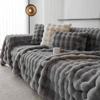 Smoky Quartz Luxe Ripple faux fur throw styled on a corner sofa with cushions and coffee