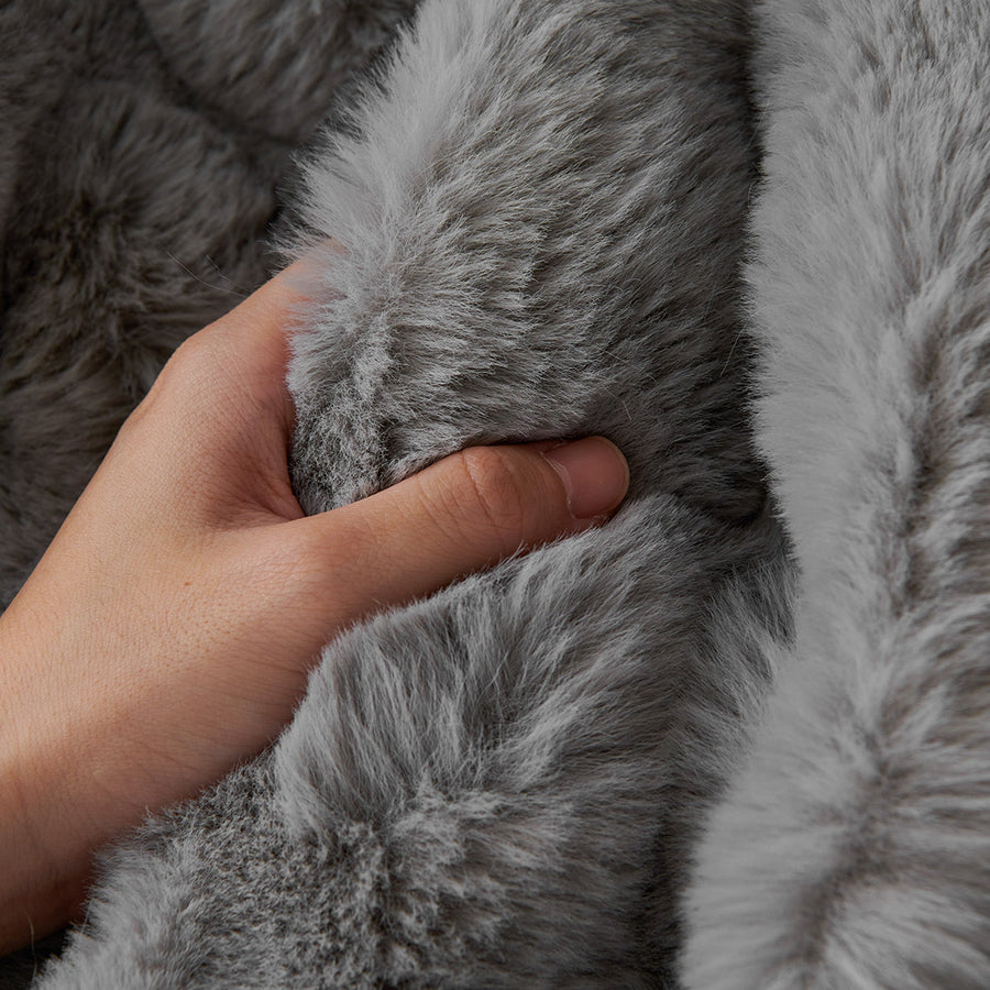 Macro of a hand pressing the Smoky Quartz Luxe Ripple faux fur showing soft ruched pile