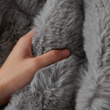 Macro of a hand pressing the Smoky Quartz Luxe Ripple faux fur showing soft ruched pile