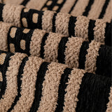 Macro close-up of Cafe Noir Metro Stripe throw showing plush woven texture and black and tan stripes