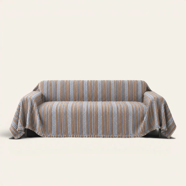 Slate Blue Metro Stripe sofa throw draped over a full couch, front view on ivory background