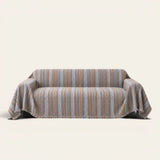 Slate Blue Metro Stripe sofa throw draped over a full couch, front view on ivory background