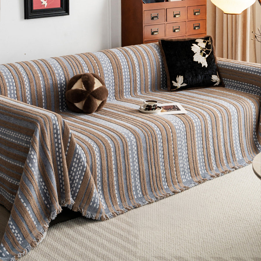 Slate Blue Metro Stripe throw over a corner sofa with cushions in a warm living room