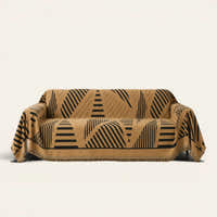 Savanna Earth Modern Jungle throw draped over a two-seat sofa on ivory background