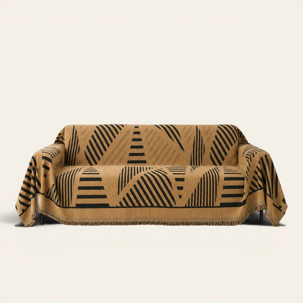 Savanna Earth Modern Jungle throw draped over a two-seat sofa on ivory background