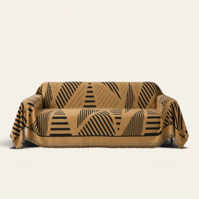 Savanna Earth Modern Jungle throw draped over a two-seat sofa on ivory background