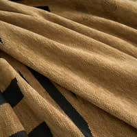 Macro of the woven chenille fabric showing camel tones and black modern lines