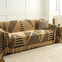 Savanna earth throw over a sofa with textured cushion beside a panelled wall