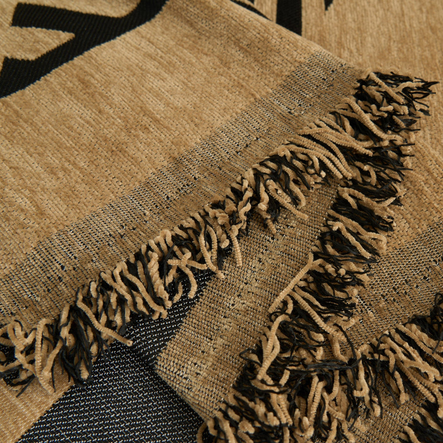 Close-up of the fringed edge showing the camel and black jungle pattern