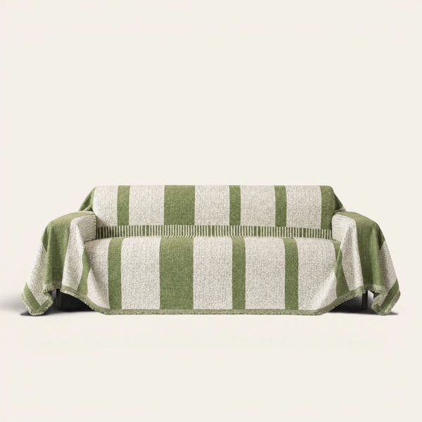 Forest green Modern Stripe sofa throw draped over a couch, front view on an ivory backdrop with fringe