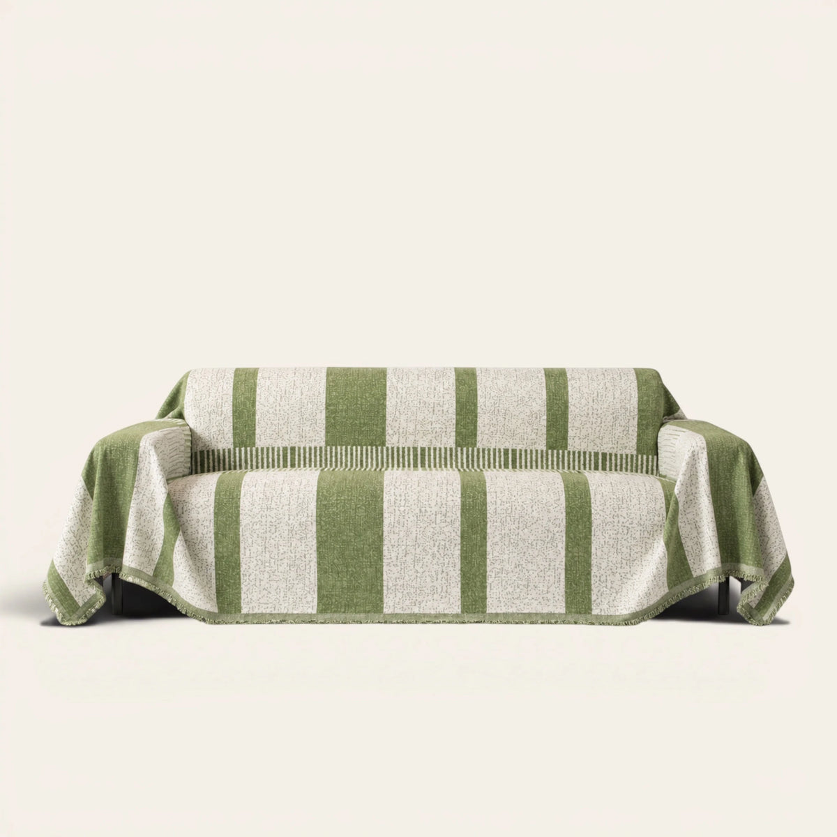 Forest green Modern Stripe sofa throw draped over a couch, front view on an ivory backdrop with fringe