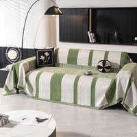Forest green Modern Stripe throw covering an L-shaped sofa in a modern living room with an arc lamp
