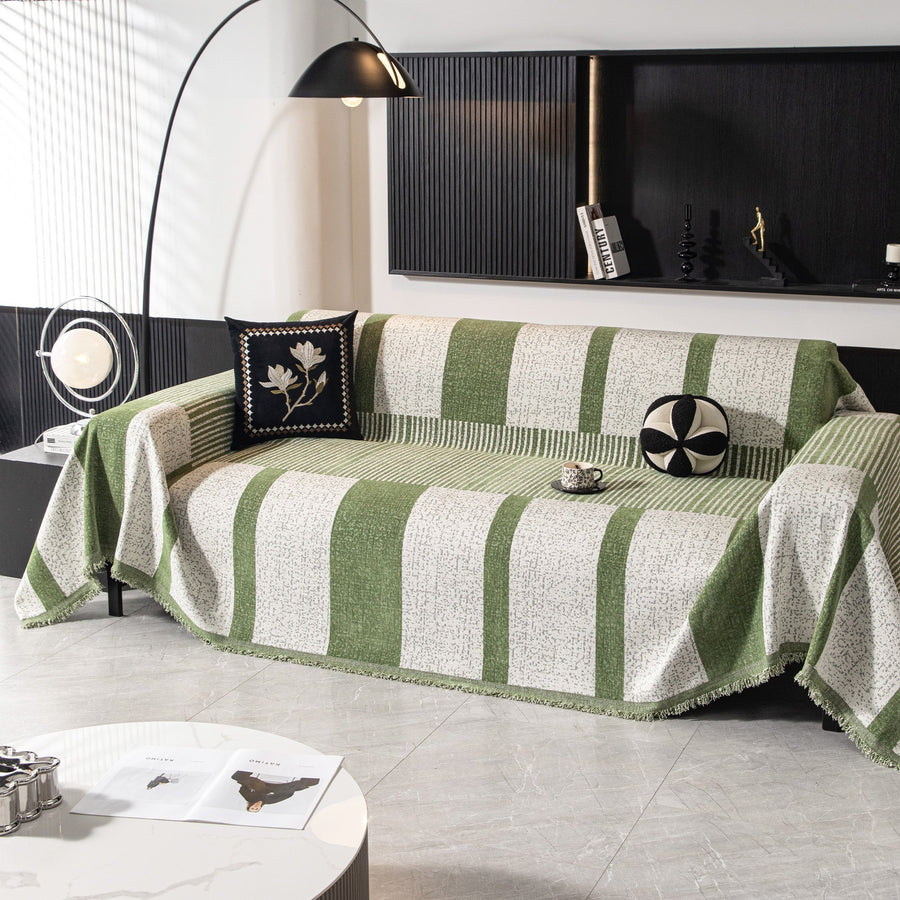 Forest green Modern Stripe throw covering an L-shaped sofa in a modern living room with an arc lamp
