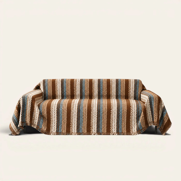 Caramel Sky Modern Striped sofa throw draped over a three seater sofa, front view on ivory background with fringed hem