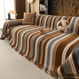 Caramel Sky Modern Striped throw over an L shaped sofa, angled view with brown cushion and decorative accents