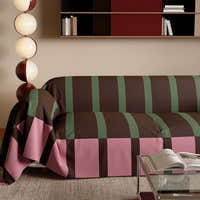 Close view of the Mocha Rose Modern Striped throw draping over the sofa arm and cushions