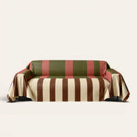 Modern Striped Olive Rust sofa throw draped over a three-seat sofa, front view on ivory