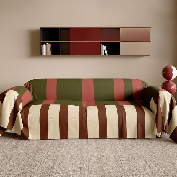 Olive Rust Modern Striped throw styled on a sofa with wall shelf and jute rug