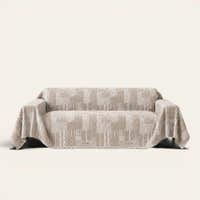 Latte Beige Modern Washed sofa throw draped over a two-seat sofa, front view on ivory background, geometric patchwork weave
