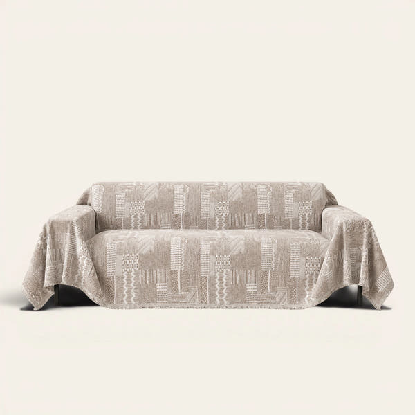 Latte Beige Modern Washed sofa throw draped over a two-seat sofa, front view on ivory background, geometric patchwork weave