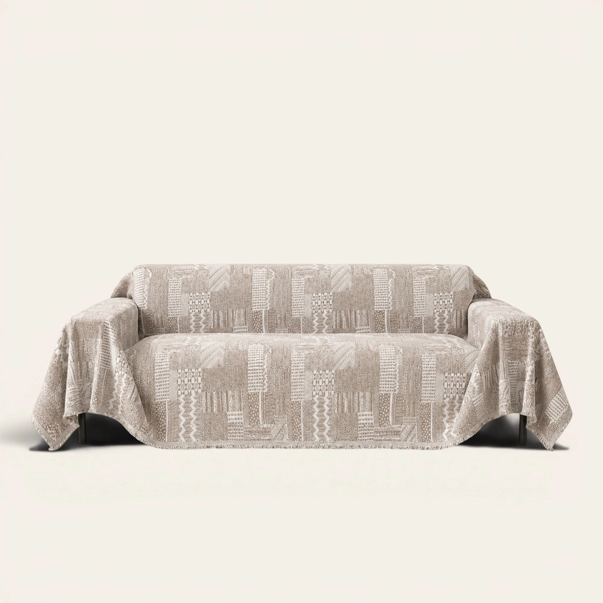 Latte Beige Modern Washed sofa throw draped over a two-seat sofa, front view on ivory background, geometric patchwork weave