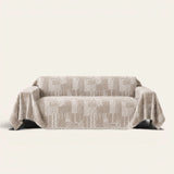 Latte Beige Modern Washed sofa throw draped over a two-seat sofa, front view on ivory background, geometric patchwork weave