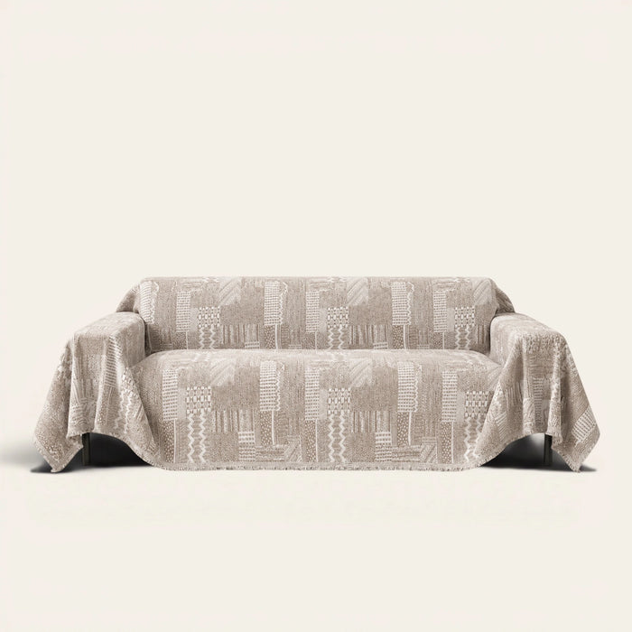 Latte Beige Modern Washed sofa throw draped over a two-seat sofa, front view on ivory background, geometric patchwork weave