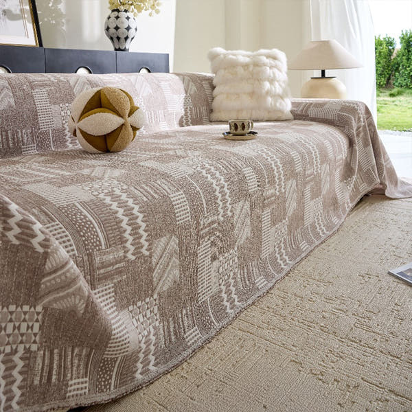 Latte Beige Modern Washed throw styled on a sofa with a soft cushion and lamp beside a bright window