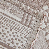 Close-up of Latte Beige Modern Washed throw, woven geometric patchwork motifs with a fringed edge