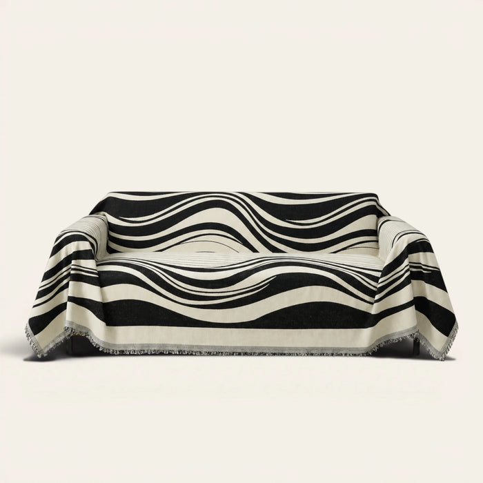 Modern Wave Monochrome Wave sofa throw draped over a three-seat sofa, front view on ivory