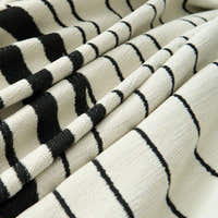 Macro of the Monochrome Wave woven fabric showing rippling black lines on cream